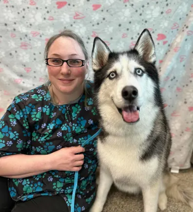 Lindsay, groomer at The Pet Spot, with a husky